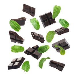 Image of Black chocolate pieces and mint falling on white background