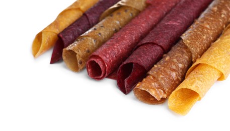 Photo of Delicious fruit leather rolls on white background