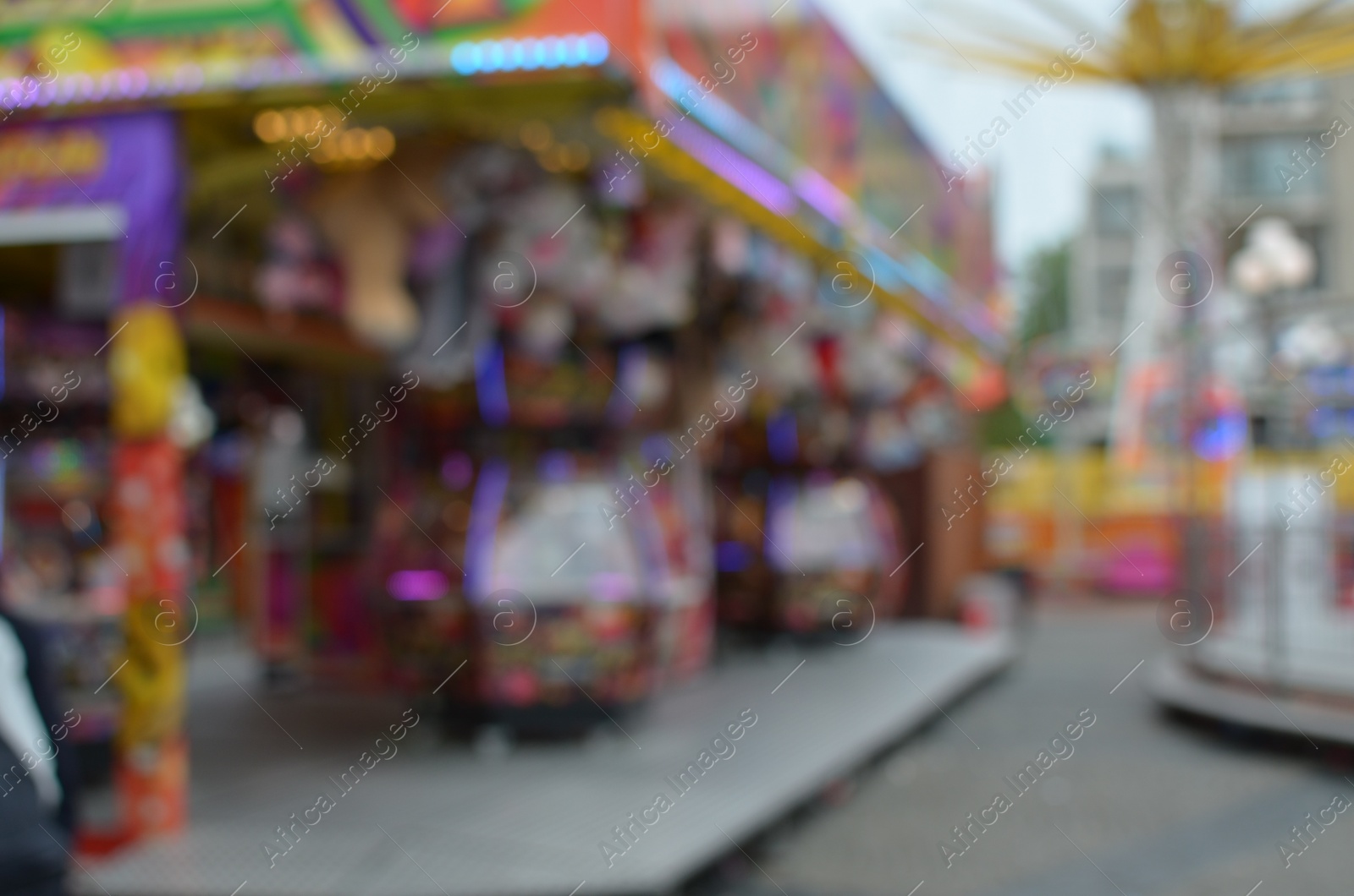 Photo of Blurred view of outdoor amusement park with different attractions