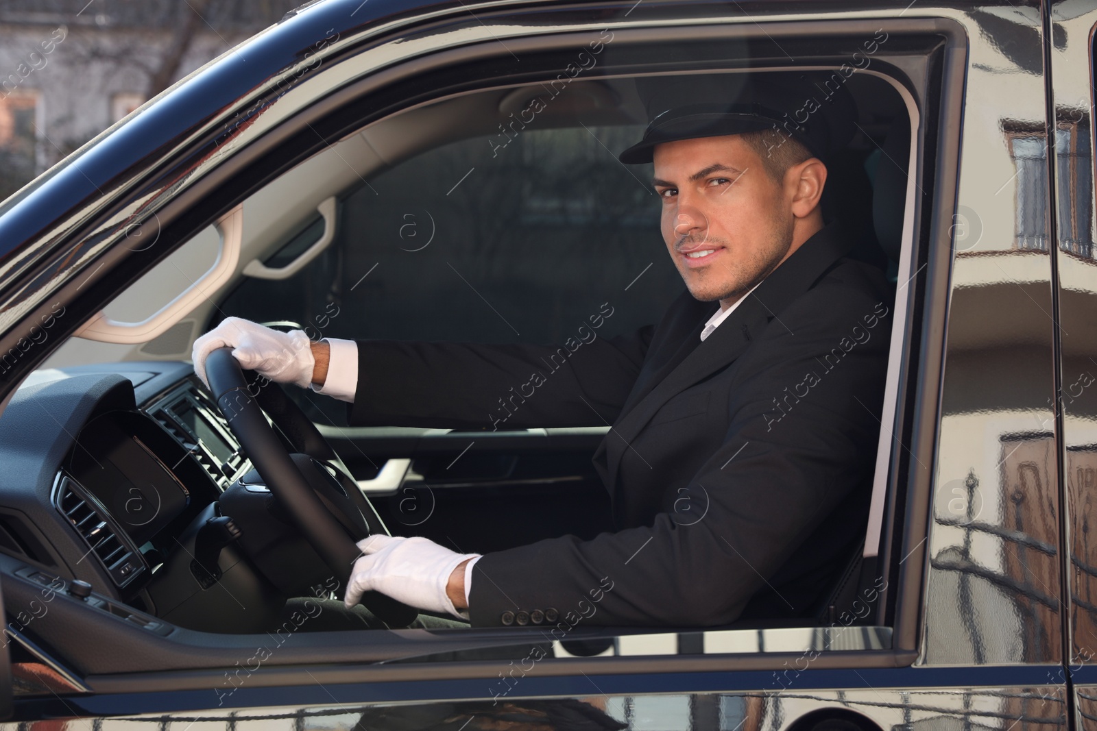 Photo of Professional driver in luxury car. Chauffeur service