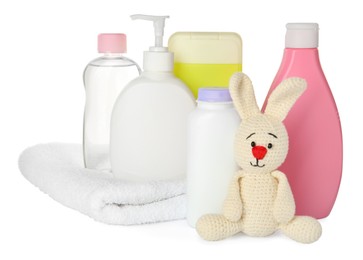 Photo of Set of baby cosmetic products, bunny toy and towel on white background