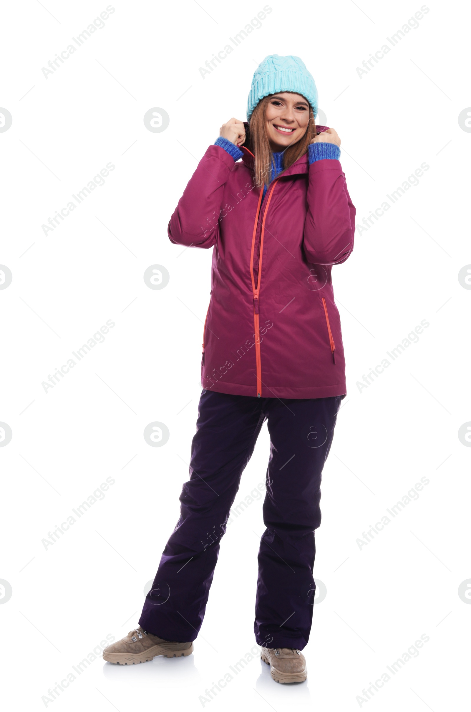 Photo of Young woman wearing warm clothes on white background. Ready for winter vacation