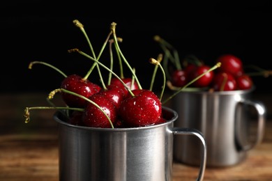 Photo of Wet red cherries in enameled mug, closeup