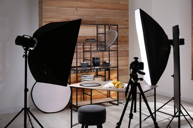 Professional equipment and many lemons on table in studio. Food photo