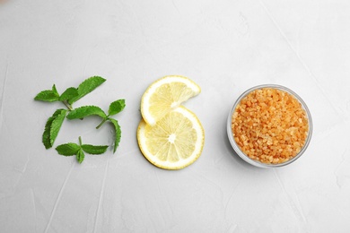 Fresh mint with sliced lemon and sugar on grey background, flat lay