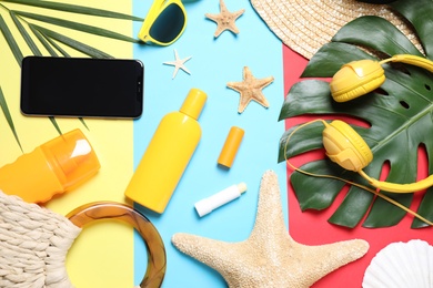 Photo of Flat lay composition with beach objects and smartphone on color background