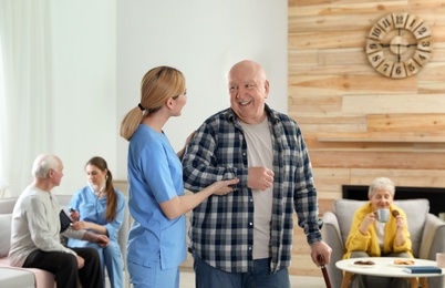 Photo of Nurses assisting elderly people at retirement home