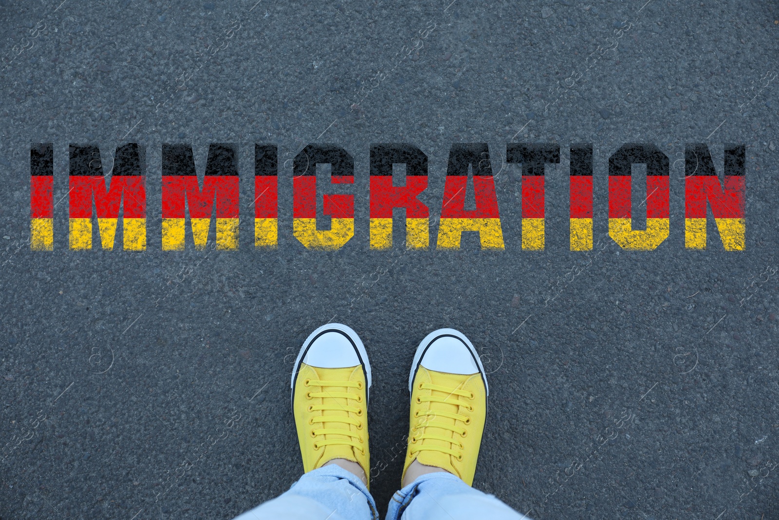 Image of Woman standing on asphalt near word Immigration in colors of flag of Germany, top view