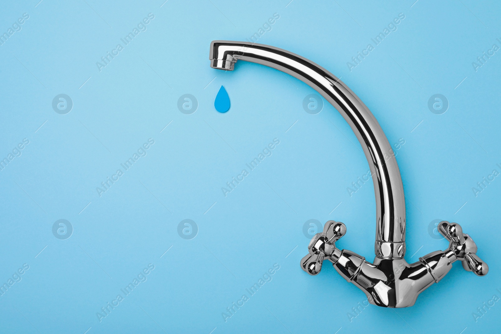 Photo of Paper water drop and modern tap on light blue background, flat lay. Space for text