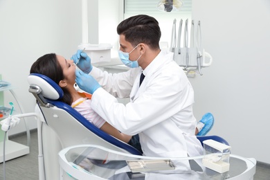 Professional dentist working with patient in clinic