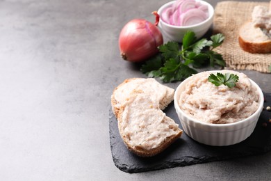 Delicious lard spread in bowl and sandwich on grey table. Space for text