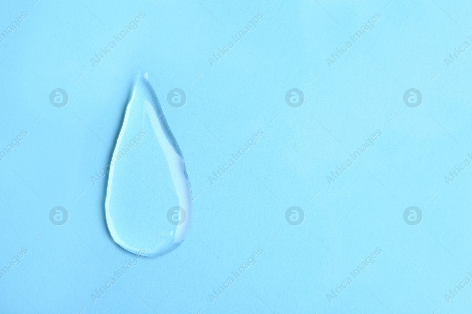 Photo of Water drop on color background, top view. Space for text