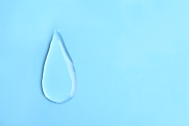 Water drop on color background, top view. Space for text