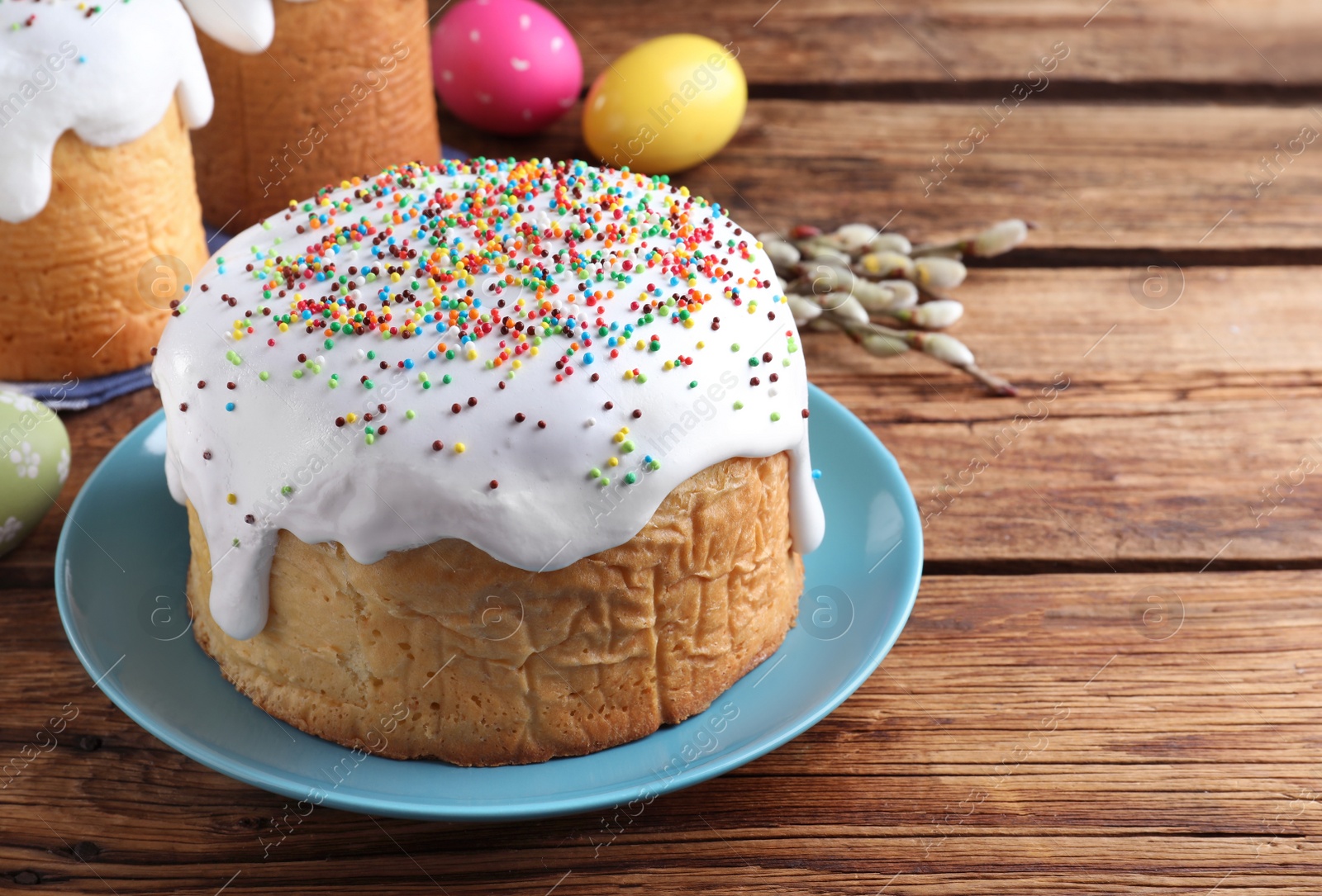 Photo of Traditional decorated Easter cake on wooden table. Space for text