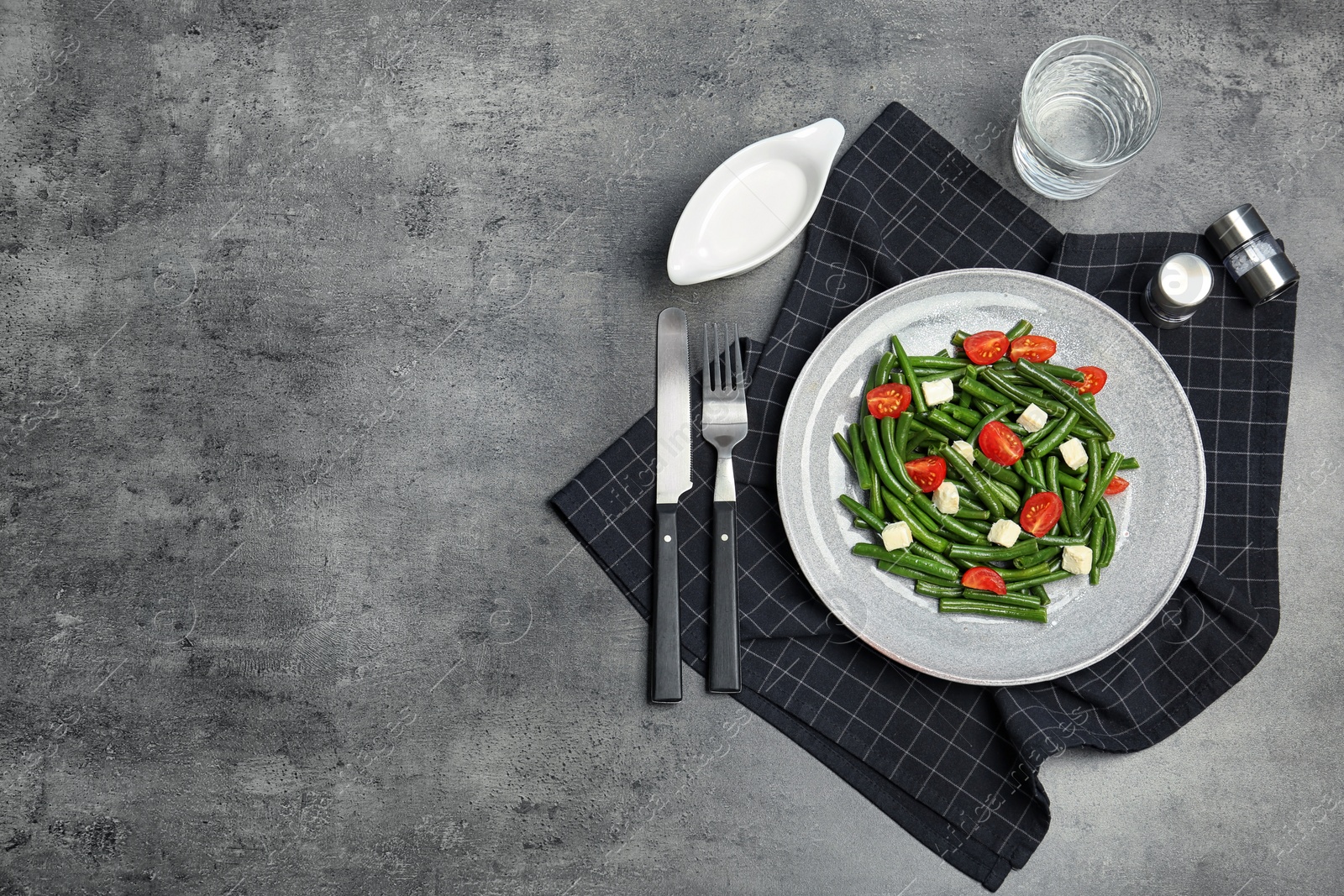 Photo of Flat lay composition with plate of fresh green bean salad on table