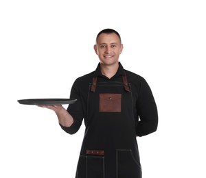 Portrait of happy young waiter with tray on white background