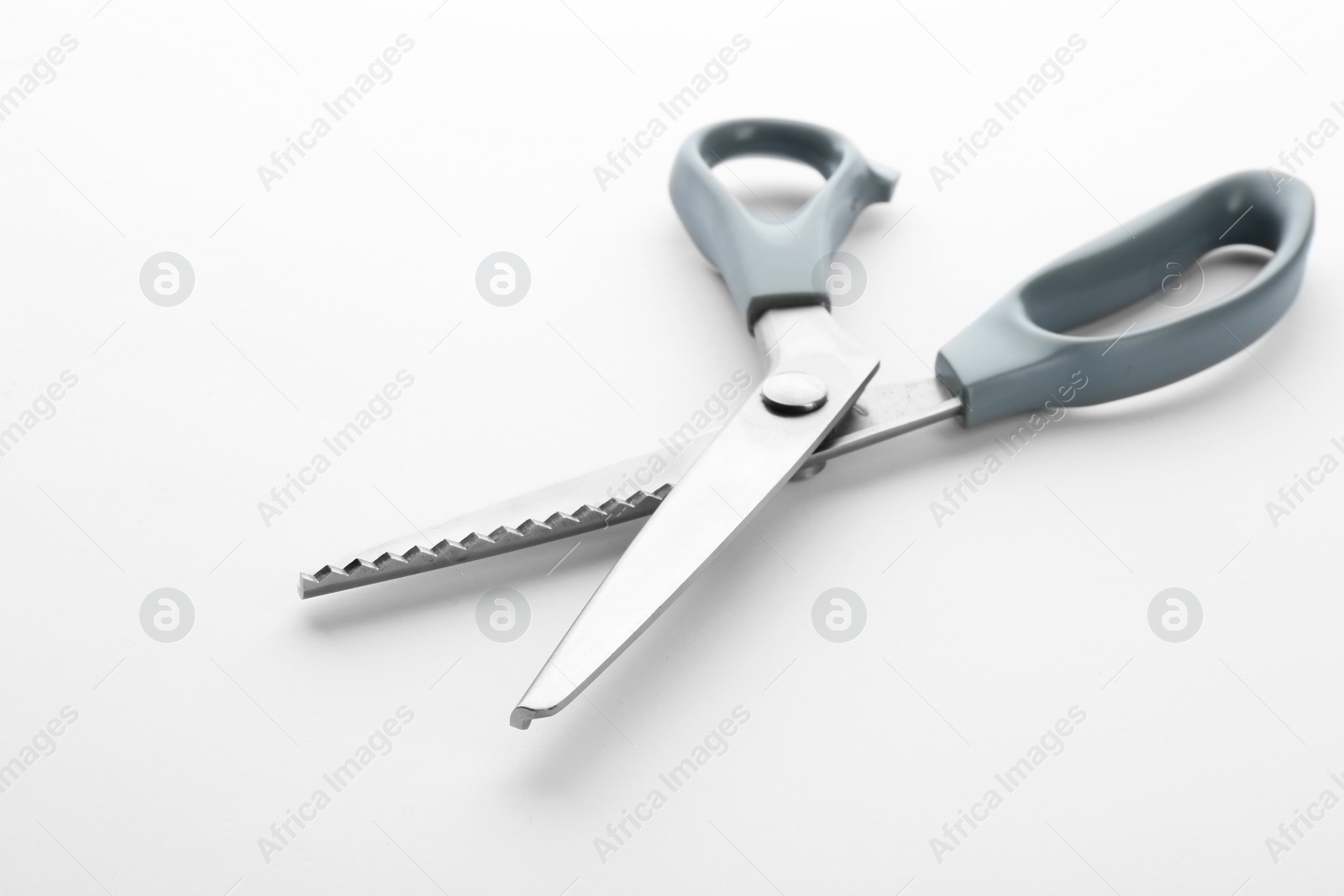 Photo of Pair of sewing scissors on white background