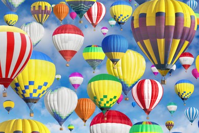 Image of Many bright hot air balloons flying in sky