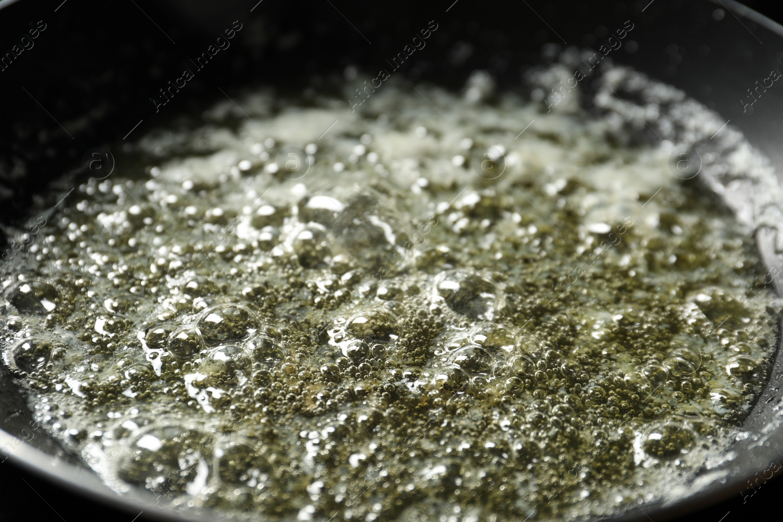 Photo of Melting butter in frying pan, closeup view