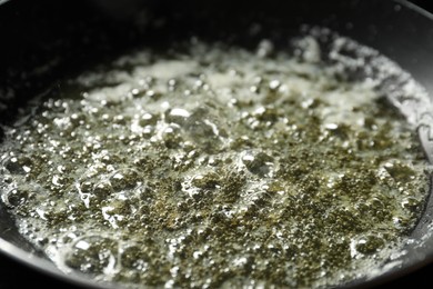 Photo of Melting butter in frying pan, closeup view