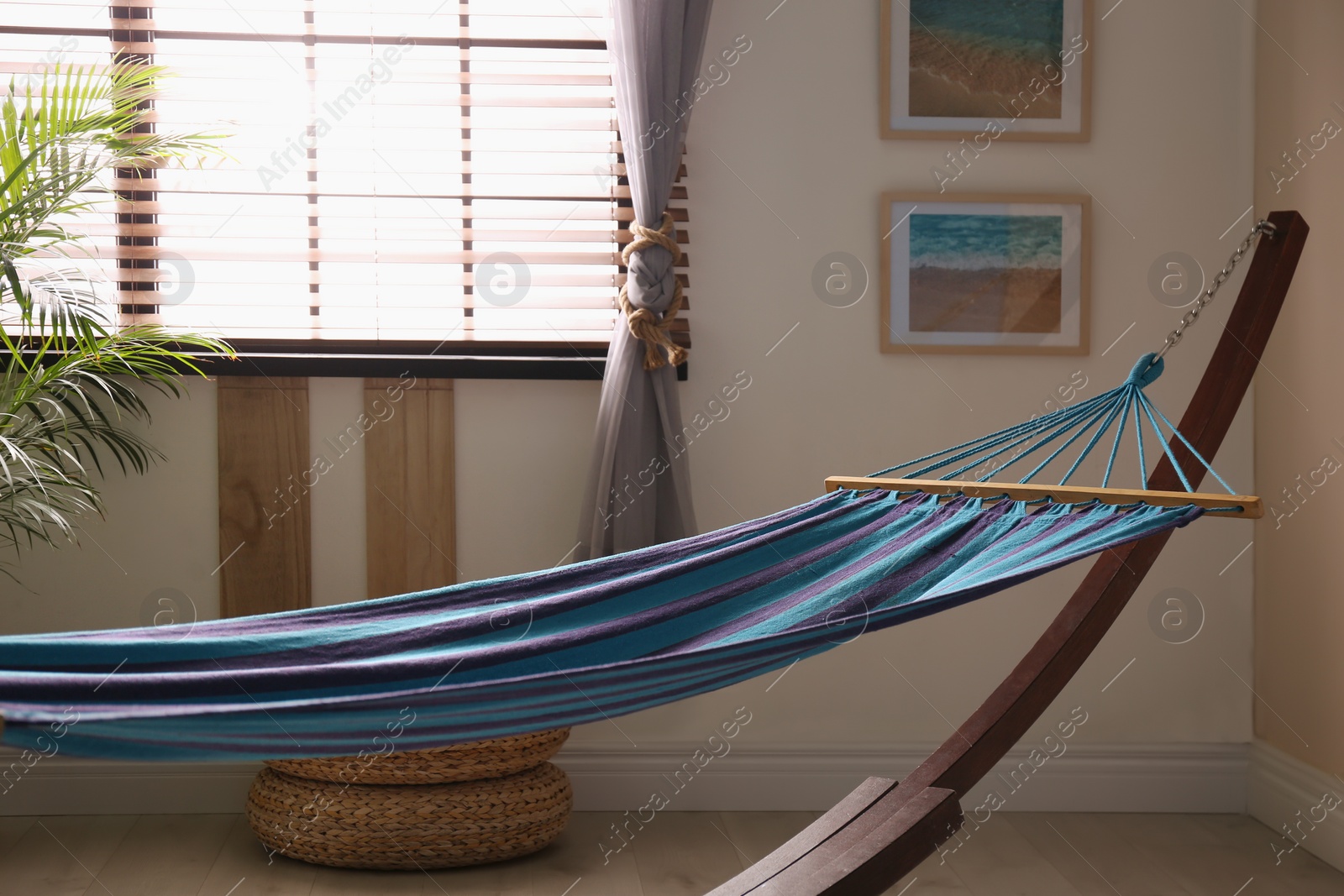 Photo of Comfortable blue hammock in stylish room. Interior design