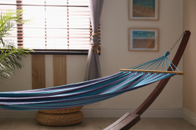 Comfortable blue hammock in stylish room. Interior design