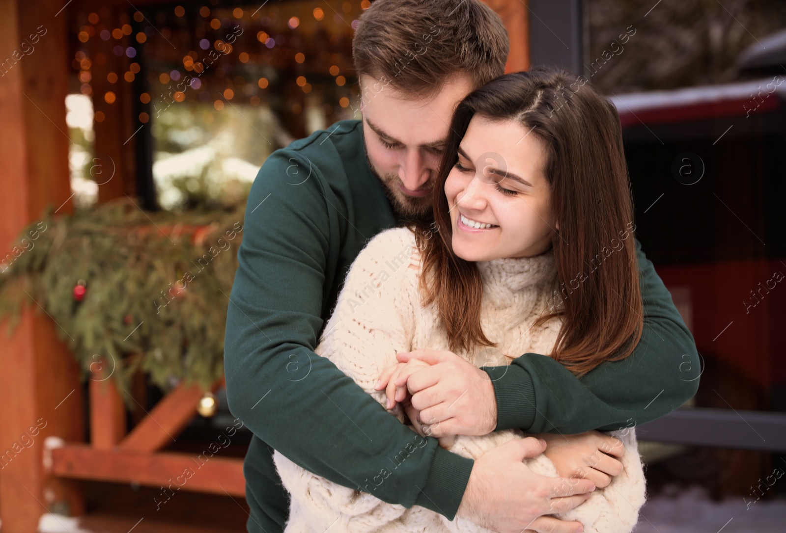 Photo of Happy couple in warm clothes outdoors. Winter vacation