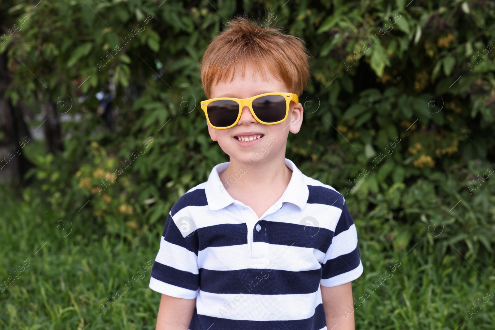 Photo of Cute little boy with sunglasses in park