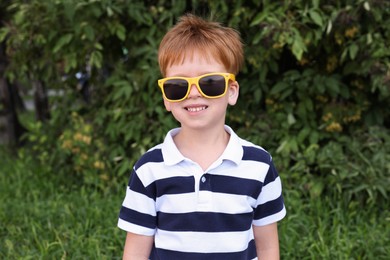 Cute little boy with sunglasses in park