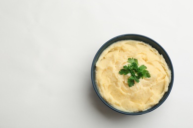 Photo of Bowl with tasty mashed potatoes and space for text on white background, top view