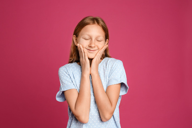 Photo of Portrait of emotional preteen girl on pink background