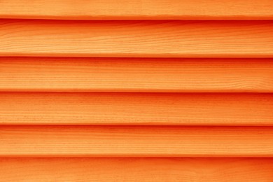 Texture of orange wooden planks as background, top view