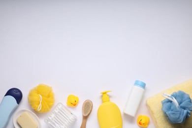 Different baby bath accessories and cosmetic products on white background, flat lay. Space for text