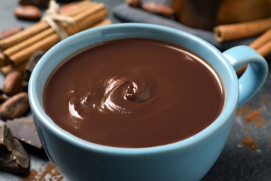 Photo of Yummy hot chocolate in cup on table, closeup