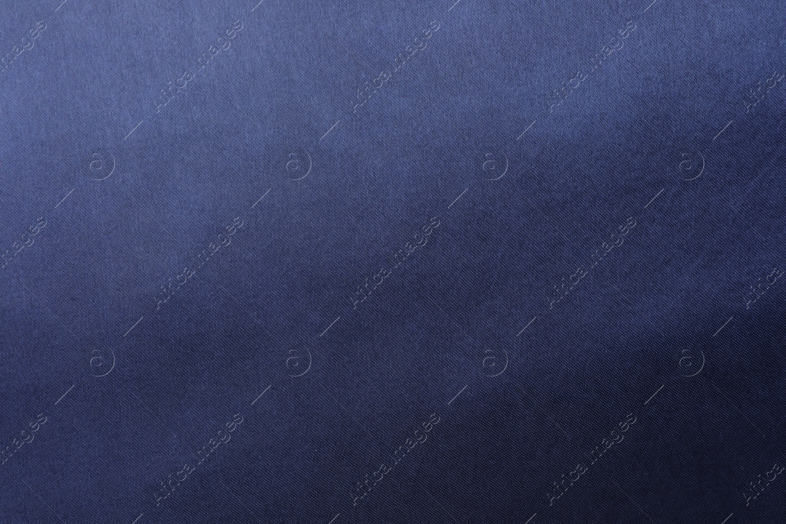 Photo of Texture of dark blue silk fabric as background, top view