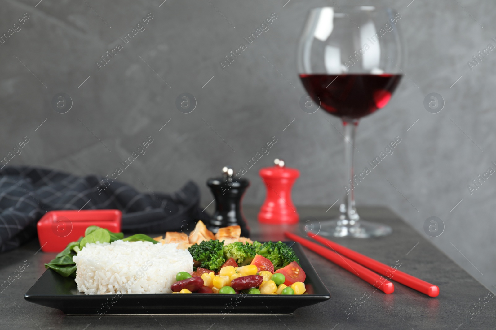 Photo of Plate of boiled rice with vegetables and meat served on table. Space for text