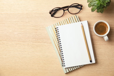 Photo of Flat lay composition with notebooks, coffee and space for text on wooden background