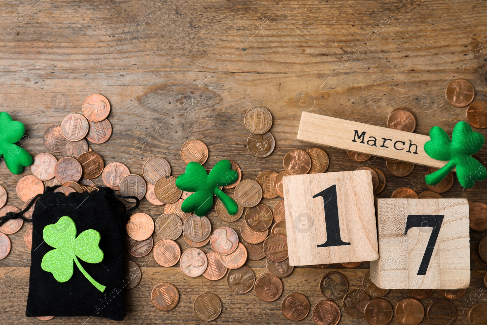 Photo of Flat lay composition with block calendar on wooden background, space for text. St. Patrick's Day celebration