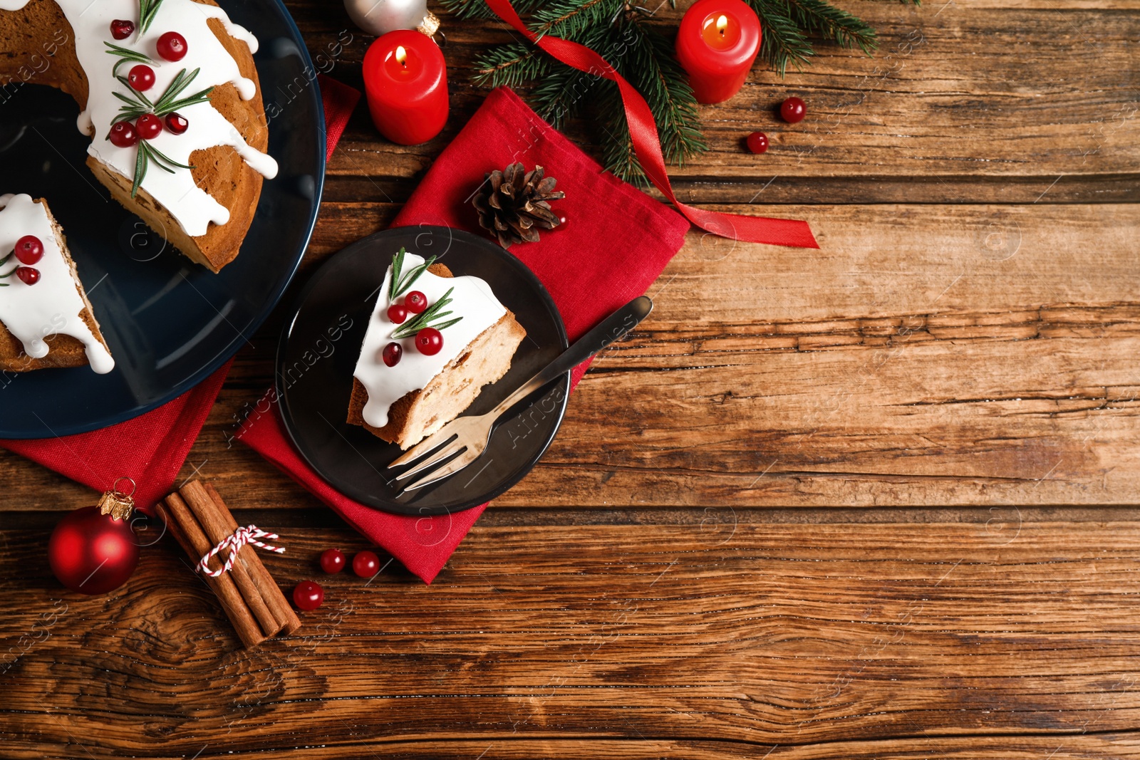 Photo of Flat lay composition with traditional homemade Christmas cake on wooden table, space for text