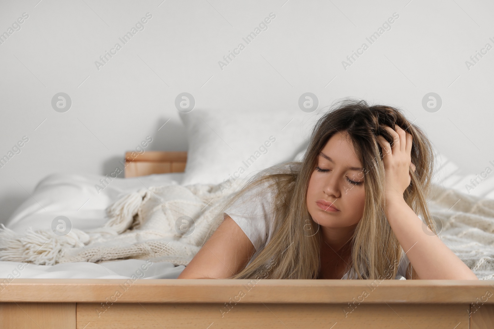 Photo of Sleepy young woman in bed at home