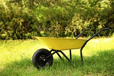Wheelbarrow on grass outside. Gardening tool