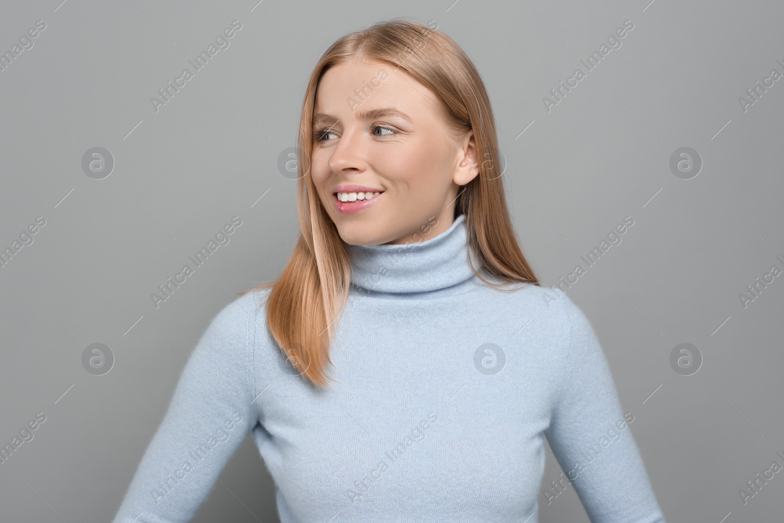 Photo of Portrait of beautiful young woman on grey background