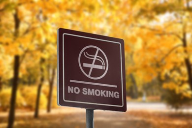 Image of Sign No Smoking in beautiful autumn park