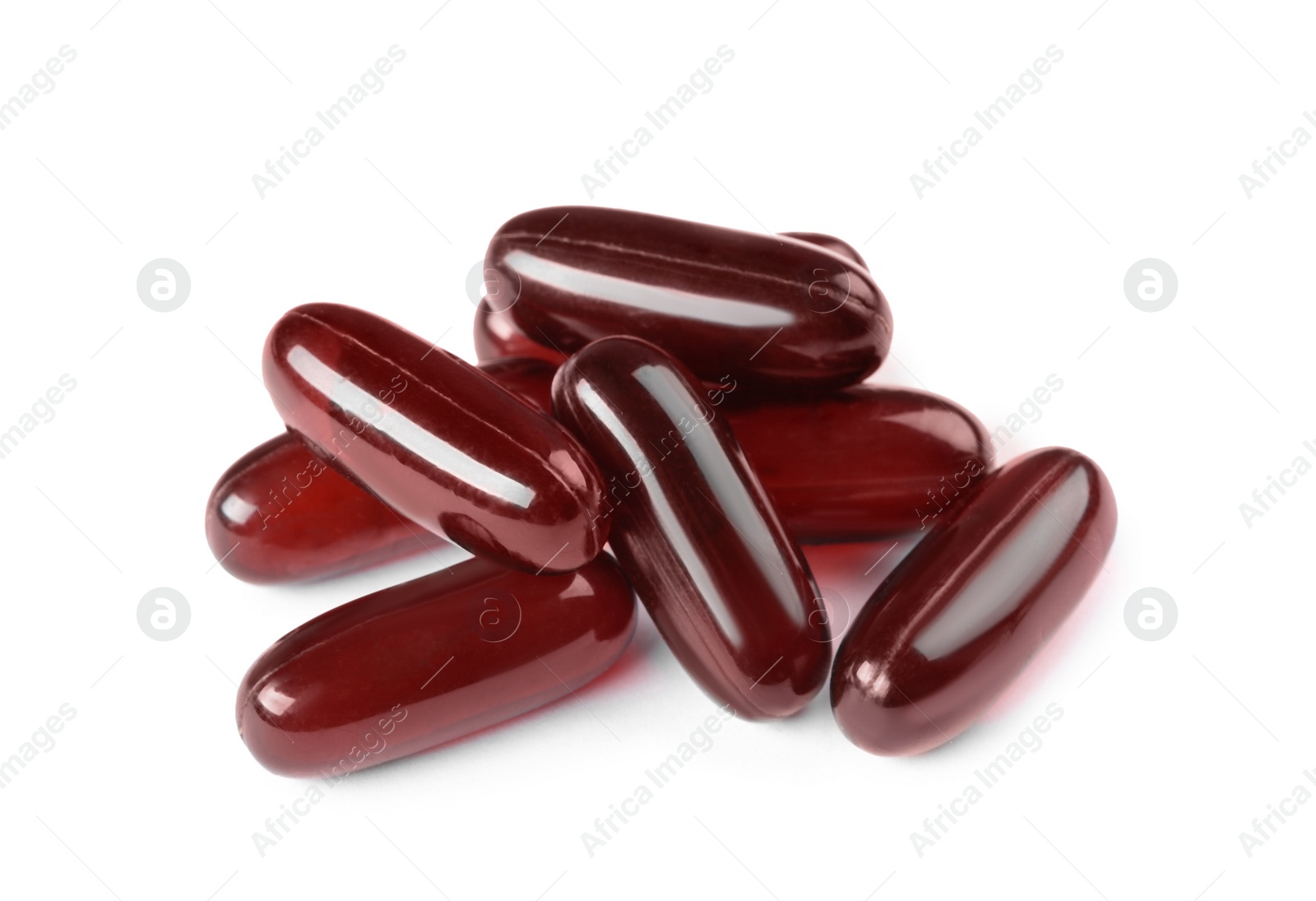 Photo of Pile of red pills on white background