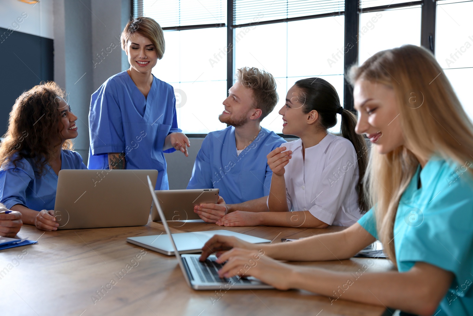 Photo of Group of smart medical students with gadgets in college