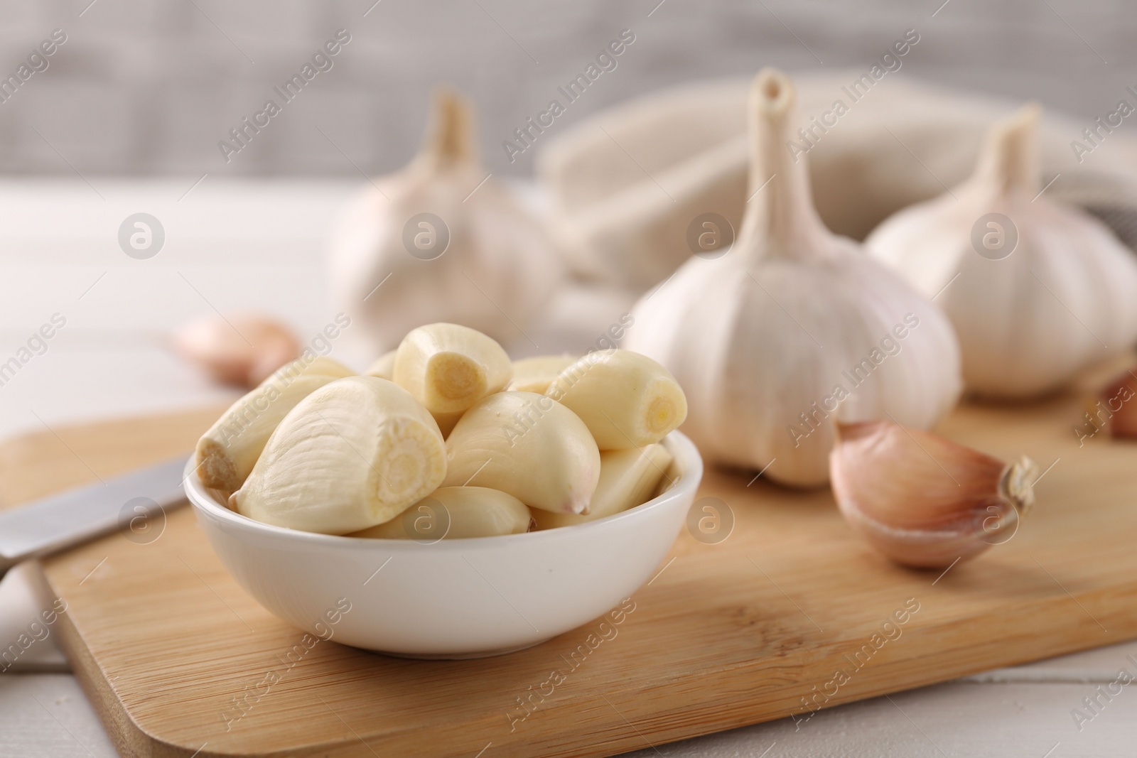 Photo of Fresh garlic on white wooden table, closeup