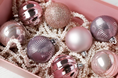 Photo of Beautiful Christmas baubles in box, closeup view