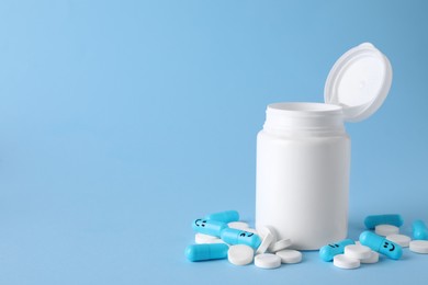 Antidepressants with happy emoticons and medical jar on light blue background, space for text