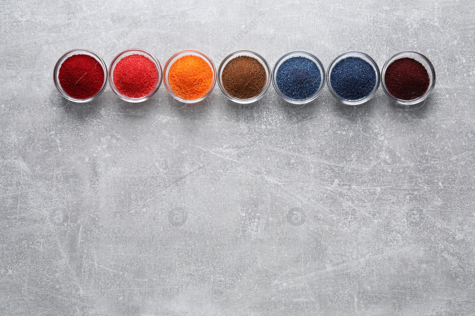 Photo of Many different food coloring on light grey table, flat lay. Space for text