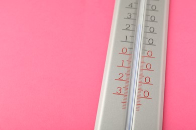 Photo of Weather thermometer on pink background, closeup. Space for text